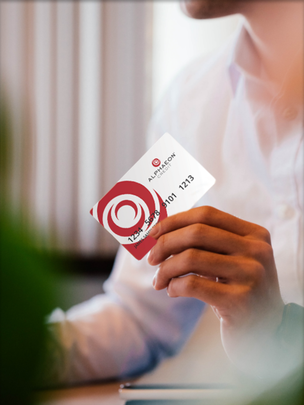 Person holding an Alphaeon credit card